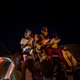 Children from the town join Ami atop a car during her processional around town; young men blasted her music from loudspeakers, announcing her arrival on May 20, 2017 in Macina, Mali.